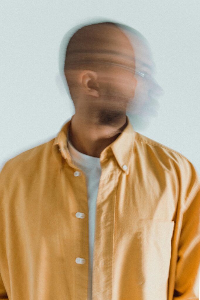 picture of a man shaking his head. His head is blurry.