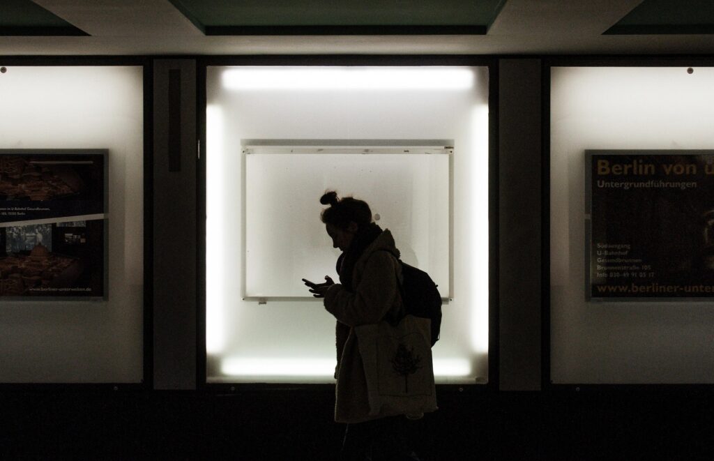 Person looking worried while analysing a text message, representing anxiety, overthinking, fear of rejection, and worrying that others are upset with them.